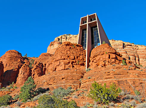 Chapel of the Holy Cross on top of Sedona Red Rocks, with vibrant blue sky in background