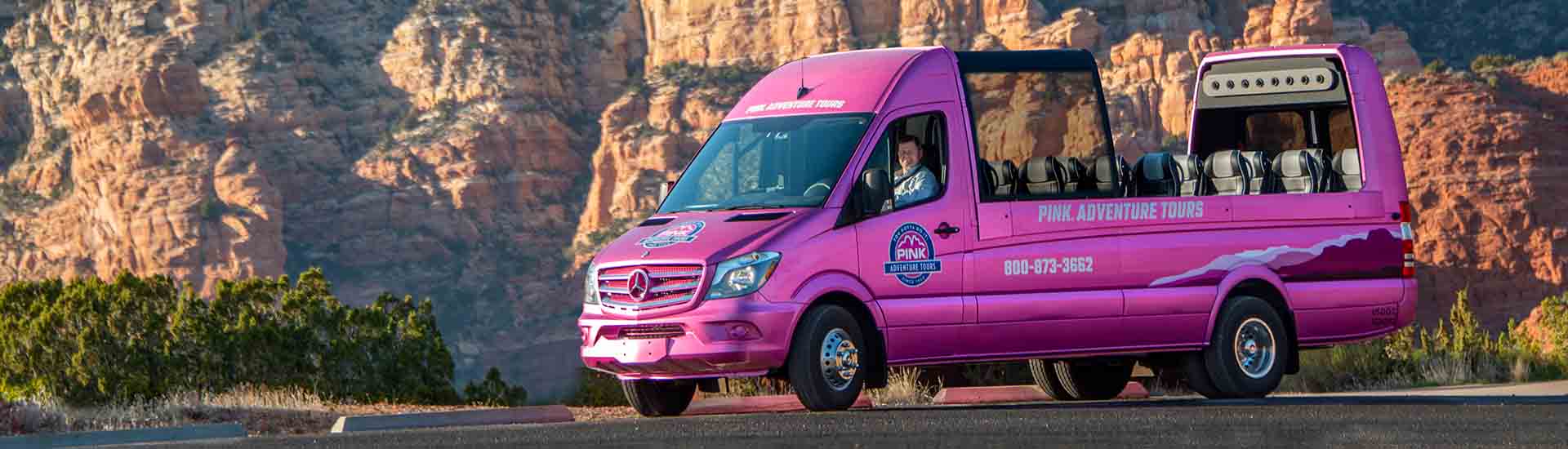 Close-up of Pink® Adventure® Tours PanoramaVan with Sedona's Thunder Mountain in background