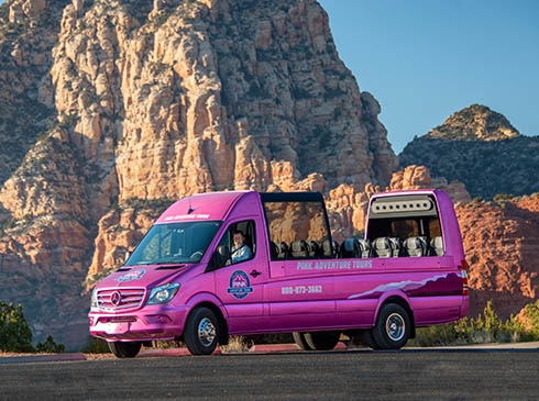 Pink® Adventure® Tours PanoramaVan parked with Sedona's Thunder Mountain in background