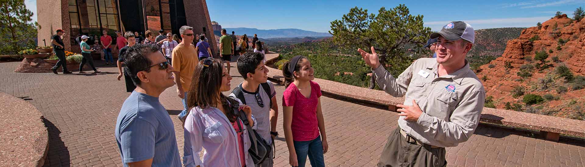 Pink Jeep Tour guide talking with guests on the Sedona 360 Tour at the Chapel of the Holy Cross