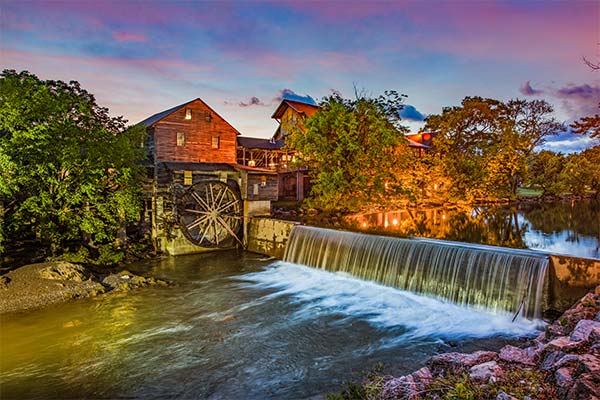 Sunrise view of the Old Mill, Pigeon Forge, TN with Little Pigeon River flowing in foreground