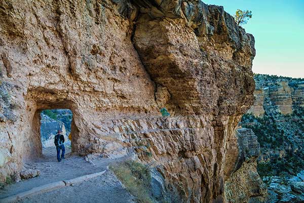 Tourist passing through the tunnel on Bright Angel Trail, just below the Grand Canyon South Rim