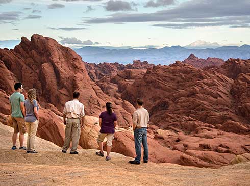 Pink Jeep guide and guests viewing geological formations at Valley of Fire State Park, Nevada