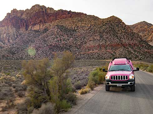Pink® Jeep Tour Trekker traveling the 13-mile scenic drive through Red Rock Canyon, NV