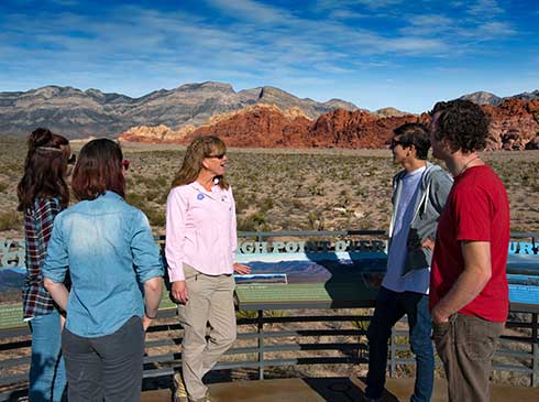 Pink Jeep interpretive guide talking with guests at Dedication Overlook in Red Rock Canyon, Las Vegas