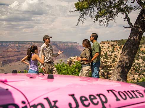 Pink Jeep guide talking with family of three overlooking the Canyon on Grand Entrance Tour