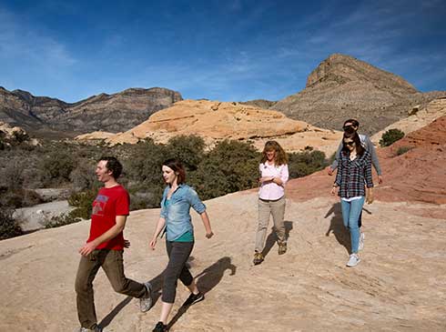 Guests scurry over jumbled sandstone formations in Red Rock Canyon outside Las Vegas.