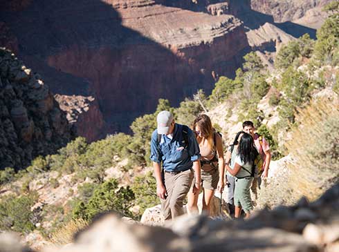 Pink Jeep tour guide leading clients up the Hermit Trail just below the Grand Canyon's South Rim.