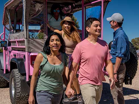 Hermits Rest Tour passengers exiting the rear of a custom Pink® Jeep® vehicle.