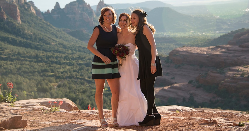 Bride and two bridesmaids on Merry Go Round Rock