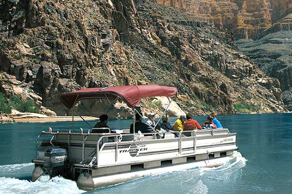 Pontoon boat with guests riding down the Colorado River