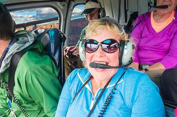 Laughing woman with sunglasses on Grand Canyon helicopter tour