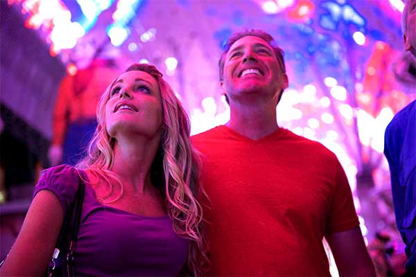 Couple walking under neon lights in Las Vegas