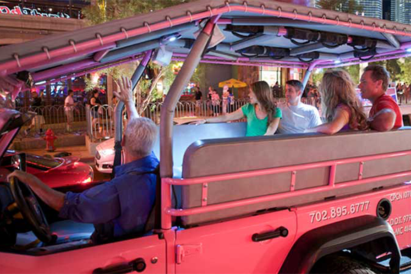 Tourists riding in Pink Jeep on Las Vegas Bright Lights city tour.
