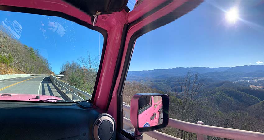 Windshield view of the Foothills Parkway and Smoky Mountains ridgelines from inside a Pink® Jeep® Wrangler.