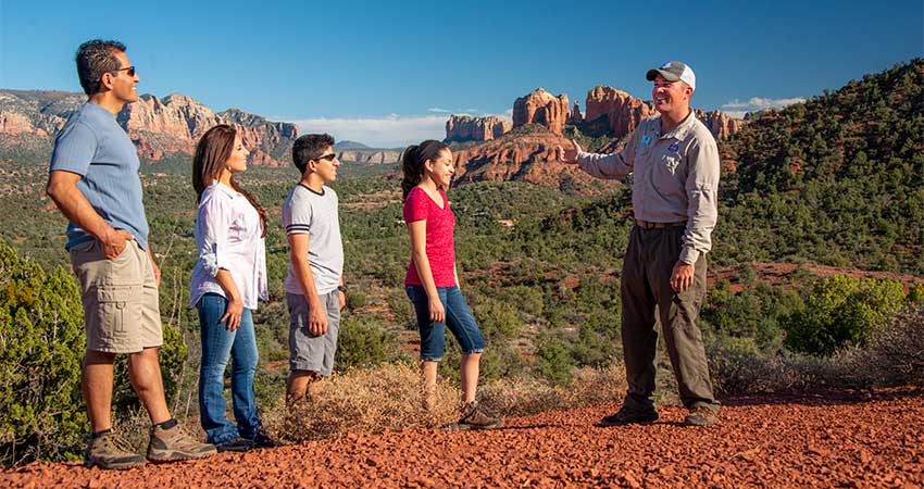 Pink Jeep Tours' guide and Sedona 360 tour guests viewing Cathedral Rock from Sedona Knolls
