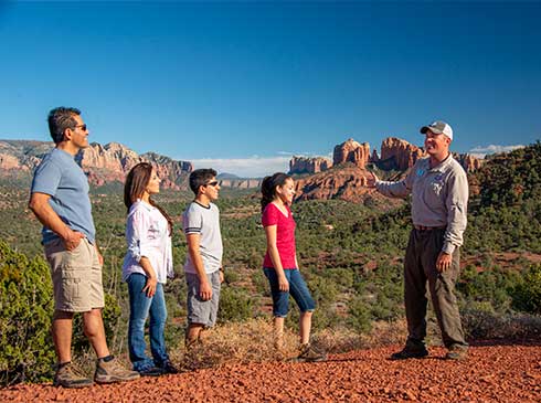 Pink Jeep Sedona 360 Tour guide and guests viewing Cathedral Rock from Sedona Knolls