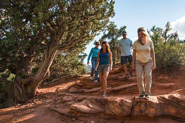 Pink Jeep Tour guests exploring the red rock trails with Aventure Guide on the Sedona Hiking Tour.