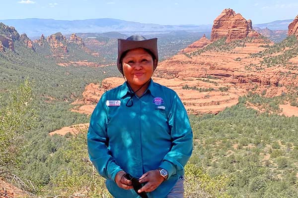 Pink® Adventure Guide Monica Polacca beautiful scene of Sedona rock formations in background.
