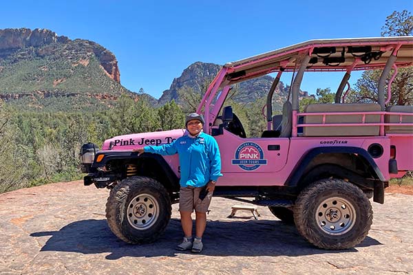 Sedona Adventure Guide Monica Polacca posing next to a Pink® Jeep® Wrangler.