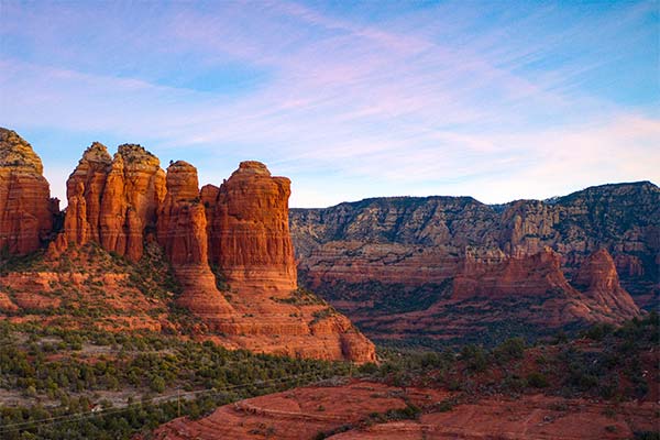 Pink sunrise over Coffee Pot Rock in Sedona, Arizona.