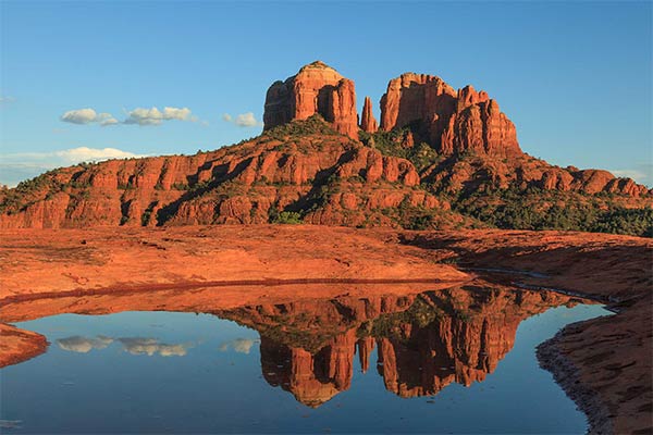 Cathedral Rock and its mirror image seen in a reflection pool in Sedona, AZ.