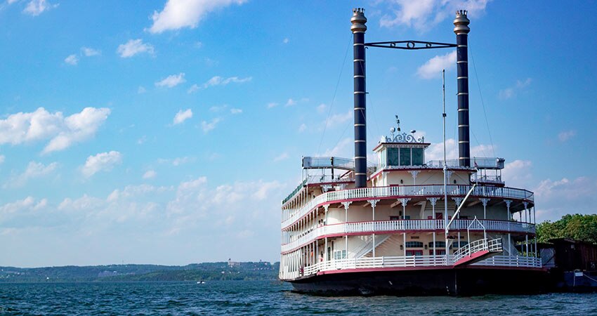 The Showboat Branson Belle parks along the shoreline of Table Rock Lake on a beautiful summer day.