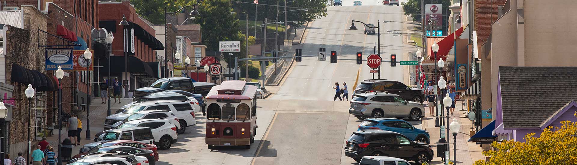 Panoramic view of Sparky, the free Downtown Branson Trolley, traveling down the hill of Main Street, Branson, MO.