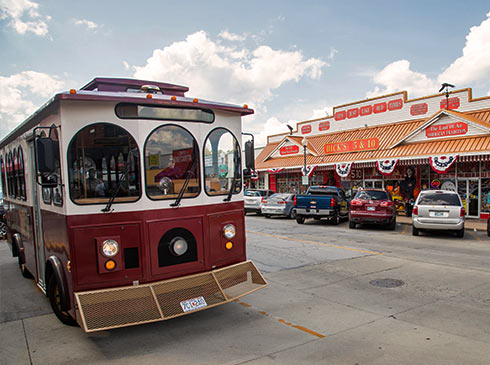 Sparky, the free Downtown Branson Trolley parked across from Dick's 5&10 in Historic Downtown Branson.