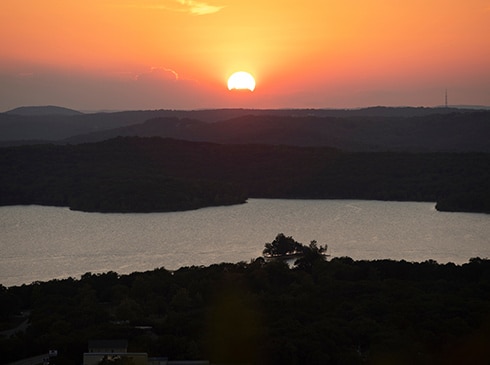 Fiery orange sunset over the Branson Hills from atop Baird Mountain, Pink® Jeep® Tours Downtown to Mountaintop Sunset Tour.