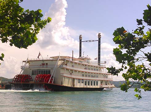 Rear view of the Branson Bell Showboat on Table Rock Lake with its red paddle wheels in motion.