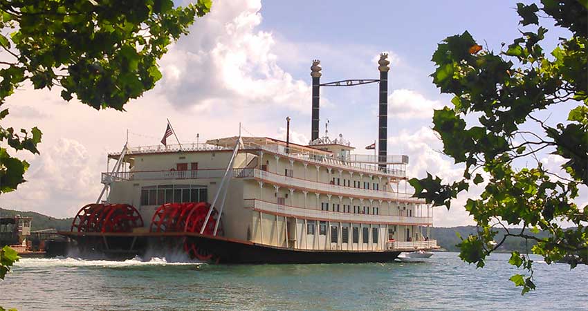 Rearview of the Branson Bell Showboat on Table Rock Lake with its red paddle wheels in motion.