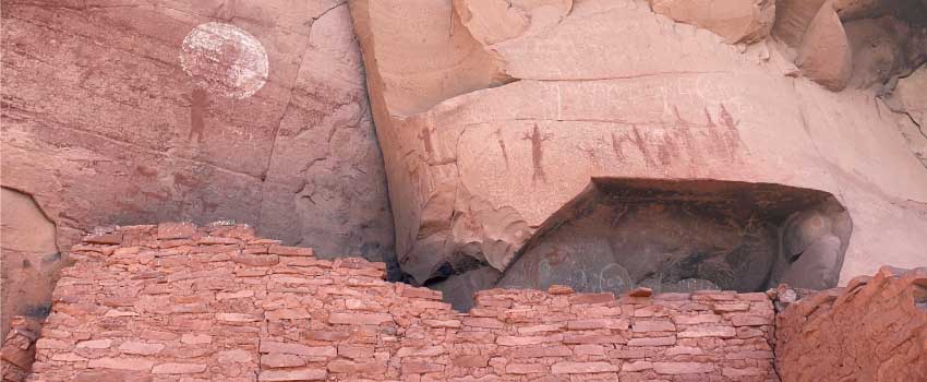 Ancient petroglyphs and painted pictographs on the walls of the red sandstone ruins at Honanki Heritage Site near Sedona, AZ.