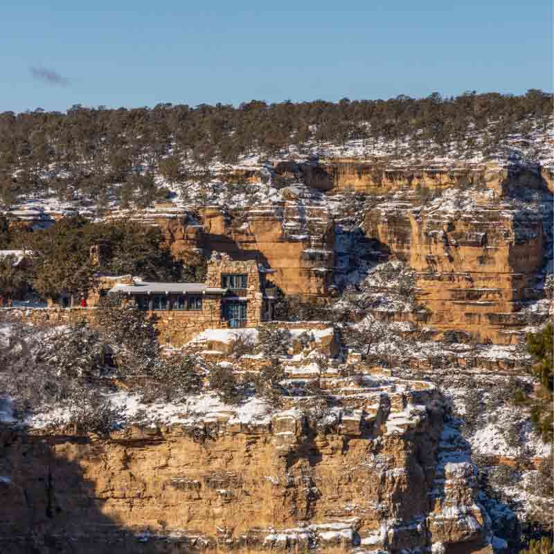 View of the Lookout Studio, designed by Mary Colter, with its walls and rooflines molded into the Grand Canyon’s sandstone cliffs.