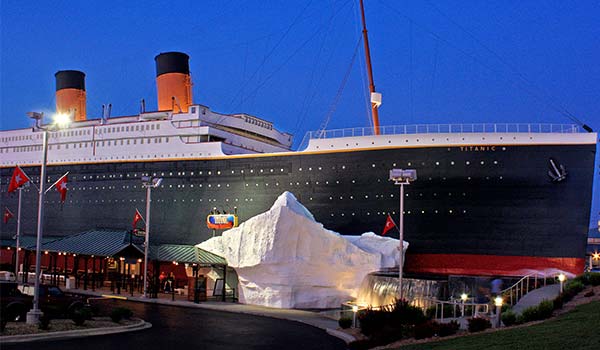 Titanic Museum Attraction and it's iceberg wall lit up at dusk in Branson, Missouri.