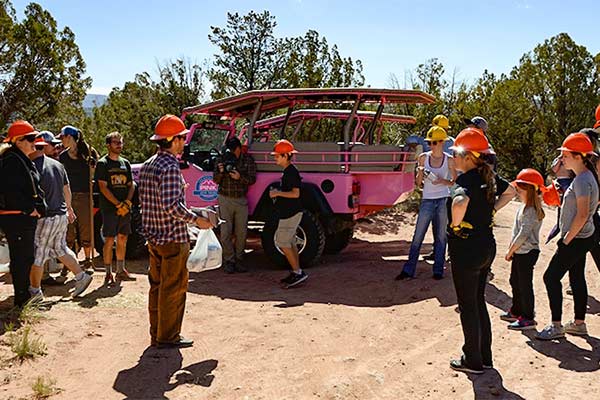 Grand Canyon litter cleanup volunteers gather around a Pink Jeep Tour guide for assignments during the 2018 Earth Day Celebration, Grand Canyon National Park.