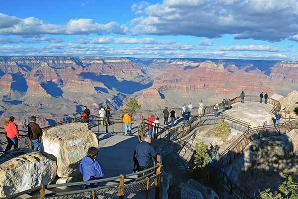 Visitors enjoying the view from the Mather Point lookout on a beautiful summer day, Grand Canyon National Park.