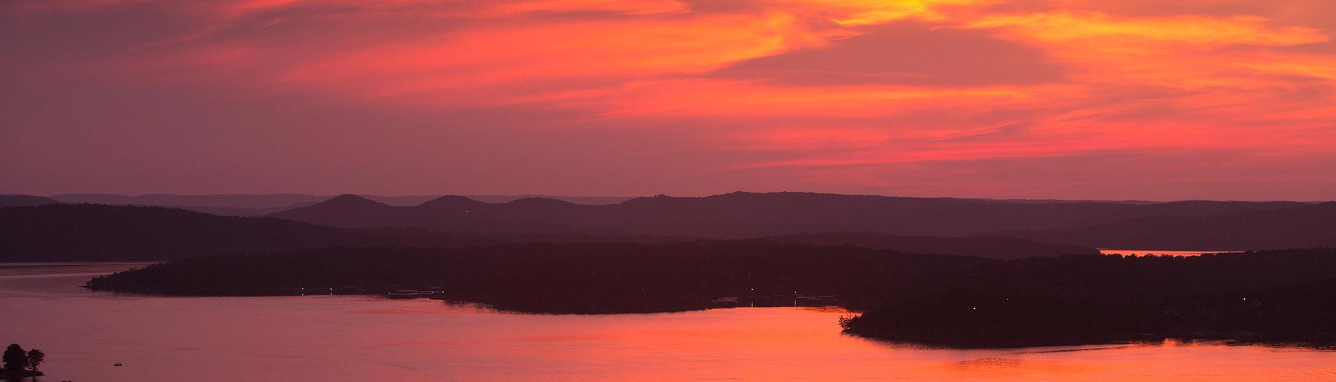 Header image of a fiery sunset turning the waters of Table Rock Lake crimson and casting a silhouette of its shoreline.