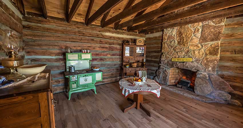 Interior living area of a historic log cabin atop Baird Mountain, accessed only with Pink Jeep Tours, Branson, MO.