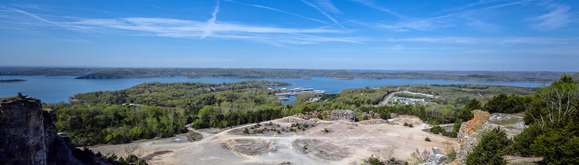 Blue sky view of Pink Jeep Tours Branson's Baird Mountain off-road course with Table Rock Lake in the background.