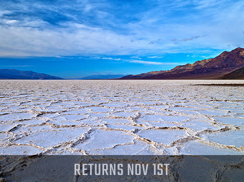 Death Valley tour mage of white salt flats with Returns Nov 1st banner.