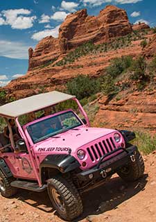 A custom-built pink Jeep Wrangler climbs Schnebly Hill Road through Sedona's rugged backcountry.