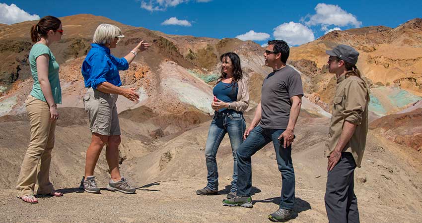 Pink Jeep tour guide talking with guests in front of the Artist’s Palette rock formation in Death Valley National Park.