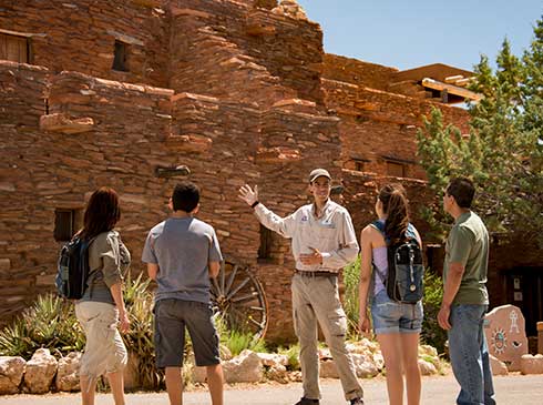 Pink Jeep guide explaining history of the Hope House to guests at Grand Canyon South Rim