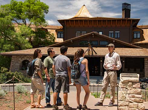 Pink Jeep guide talking with tour group in front of El Tovar Hotel, Grand Canyon South Rim