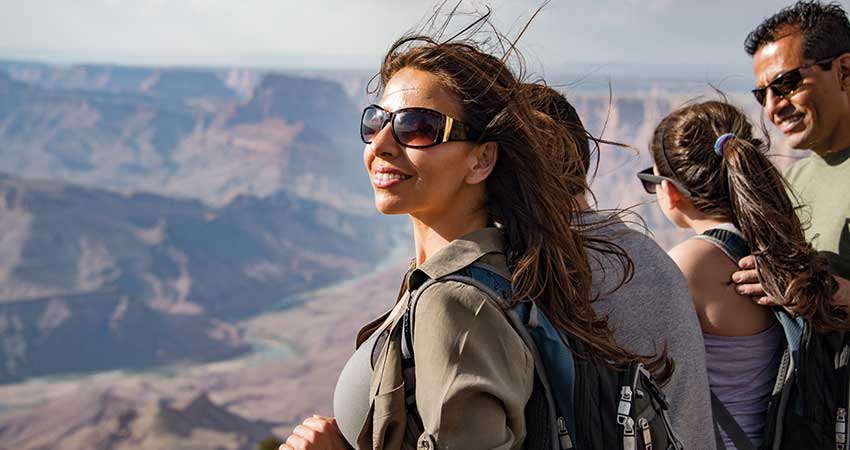 Close-up of a family looking at the Grand Canyon from a viewpoint on Pink Jeep® Tours Desert View Sunset tour.