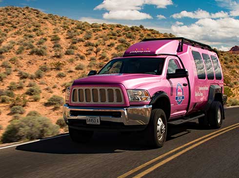 Close-up of Pink Adventure Tour Trekker traveling through Mohave Desert en route to Hoover Dam