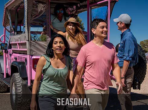 Grand Canyon Hermits Rest Hiked & Jeep Tour guests exiting the back of Pink Jeep® Wrangler with Seasonal banner.