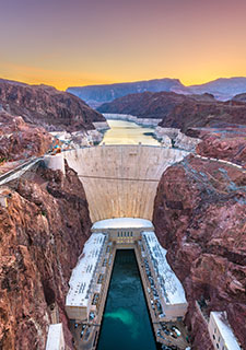 Aerial view of warm sunset over Hoover Dam and the Colorado River near Las Vegas, Nevada.