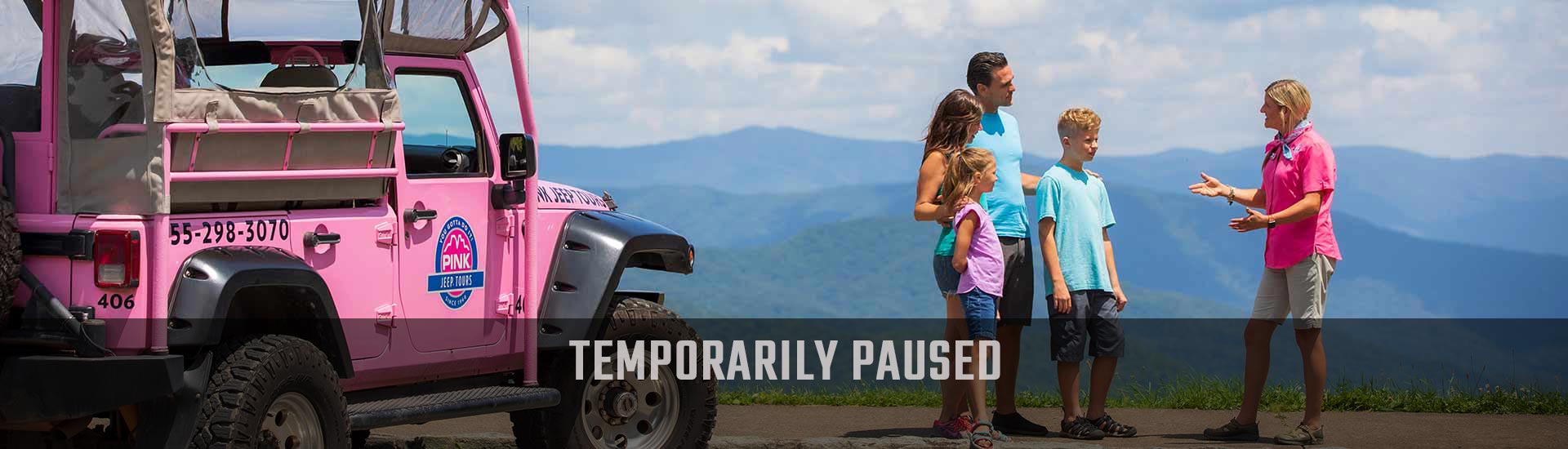 Newfound Gap tour guide talking to guests next to Pink® Jeep®, with Smoky Mountains in the background and Temporarily Paused banner.